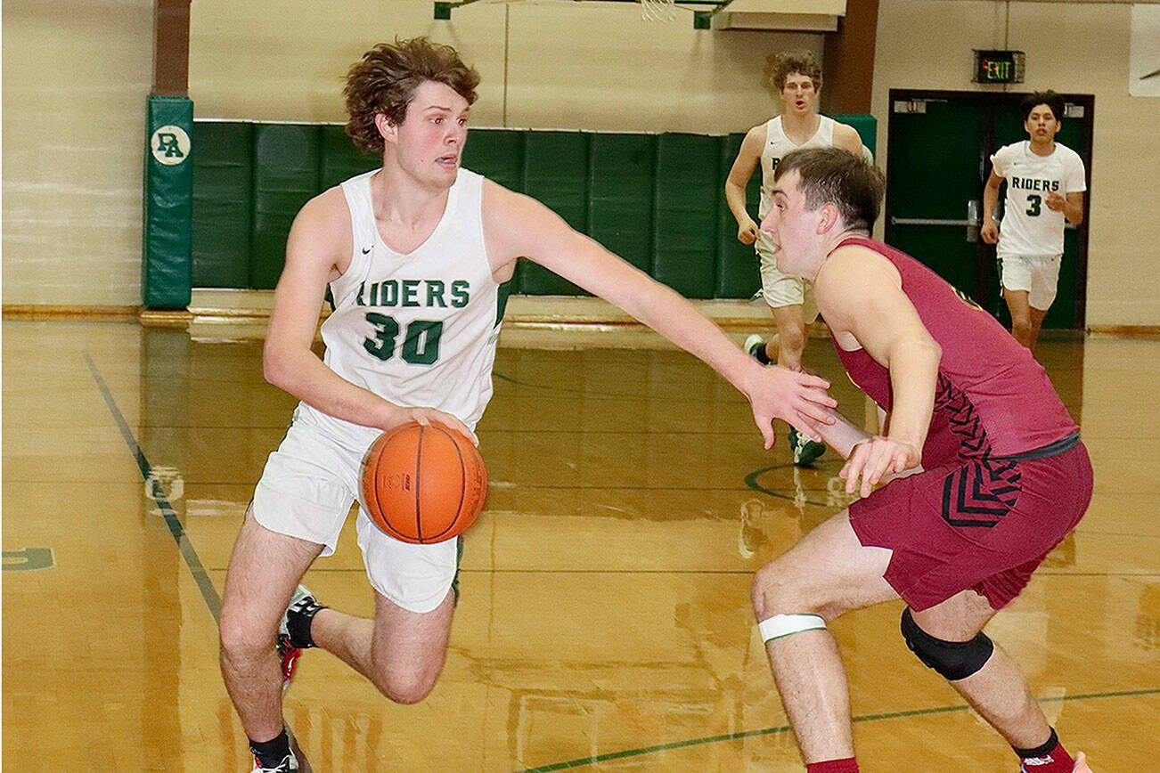 #30 Wyatt Dunning of the PA Riders drives around the guarding of a Kingston defender Tuesday night at the PAHS gym. dlogan