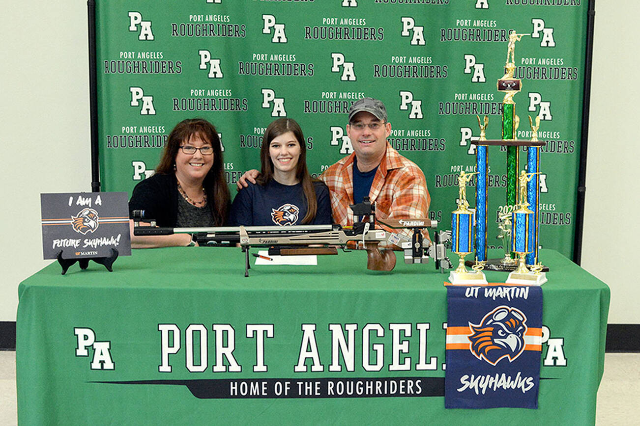 Carmen Geyer/Port Angeles School District
Port Angeles' Cheyenne Maggard, center, is joined by her parents Meghan and Brent as she signs her letter of intent to compete in air rifle at the University of Tennessee-Martin.