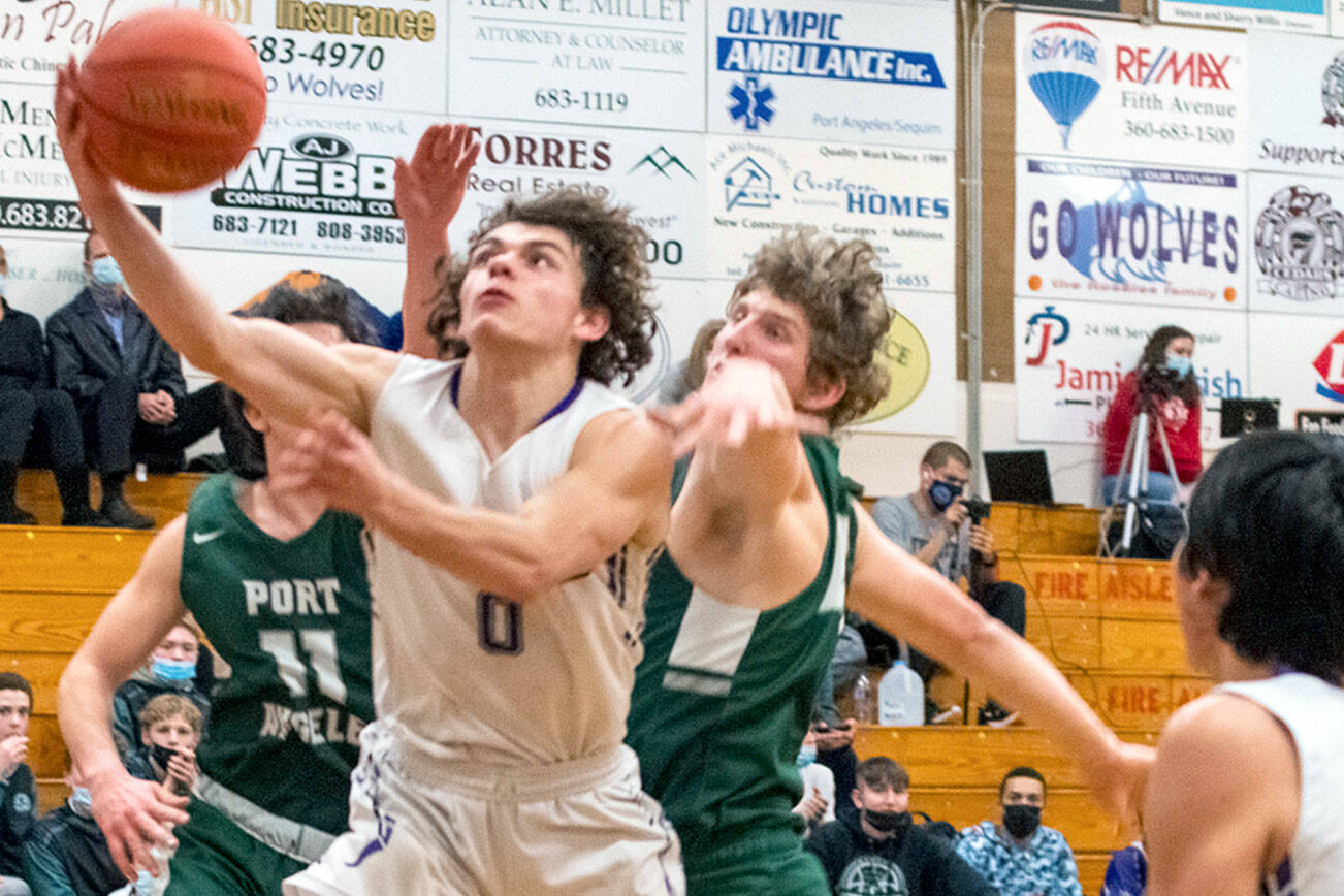 Emily Matthiessen/Olympic Peninsula News Group
Sequim's Tyler Mooney puts up a layup while defended by Port Angeles' Xander Maestas, at left, and John Vaara during the Roughriders' 62-49 victory Thursday.