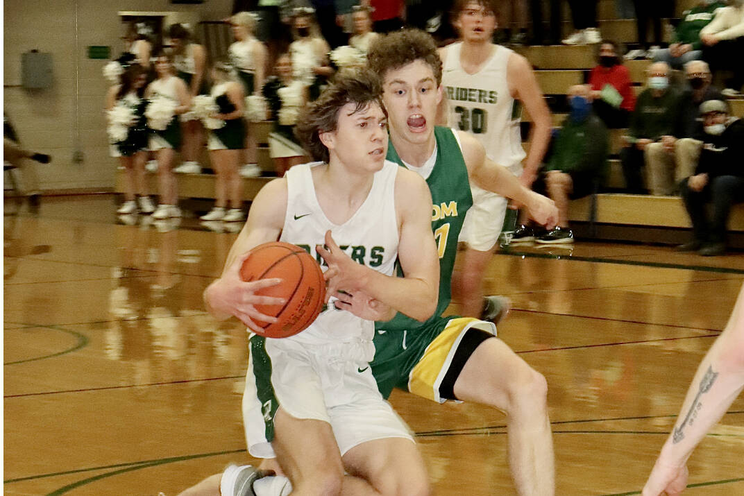 Port Angeles' Parker Nickerson drives against Sehome's Grant Kepley on Friday night in Port Angeles. Nickerson scored 11 points in the third quarter to help spark a Roughriders comeback win. (Dave Logan/for Peninsula Daily News)