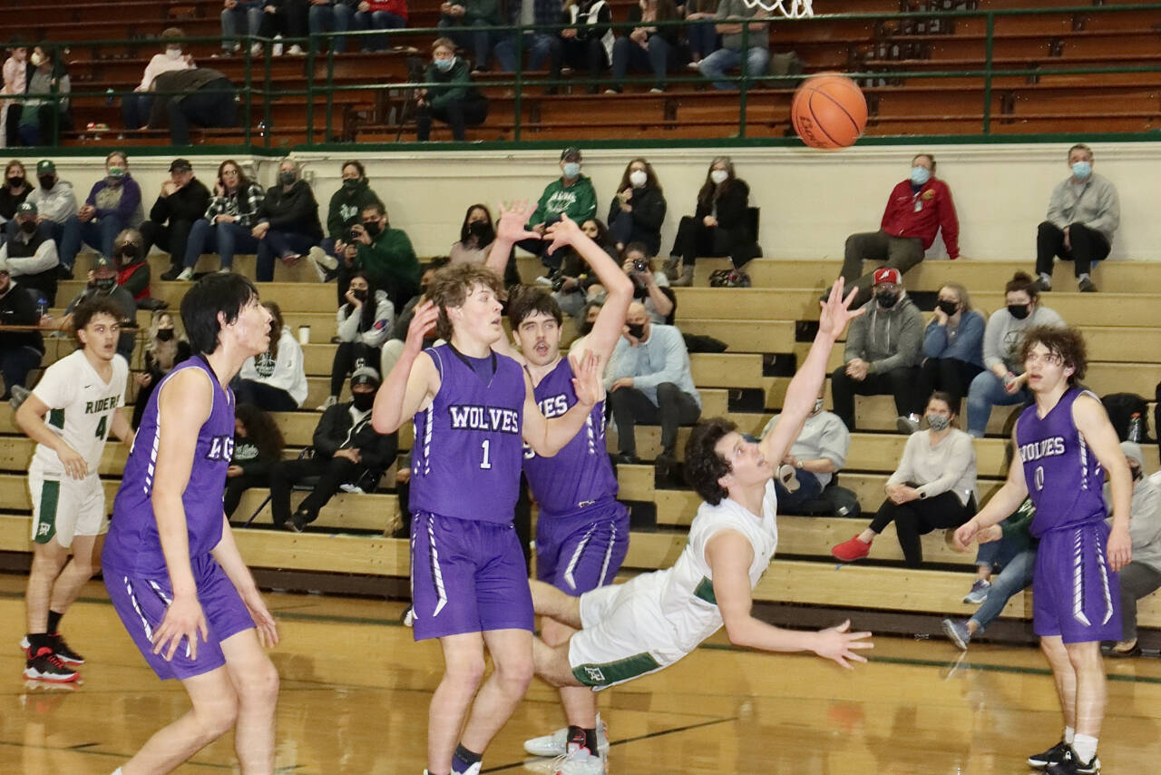 Port Angeles' Xander Maestas actually made this shot Saturday against Sequim and picked up a foul for a 3-point play Saturday. Also in on the play are, from left, Sequim's Isaiah Moore, Zach Thompson, Cole Smithson and Tyler Mooney. (Dave Logan/for Peninsula Daily News)