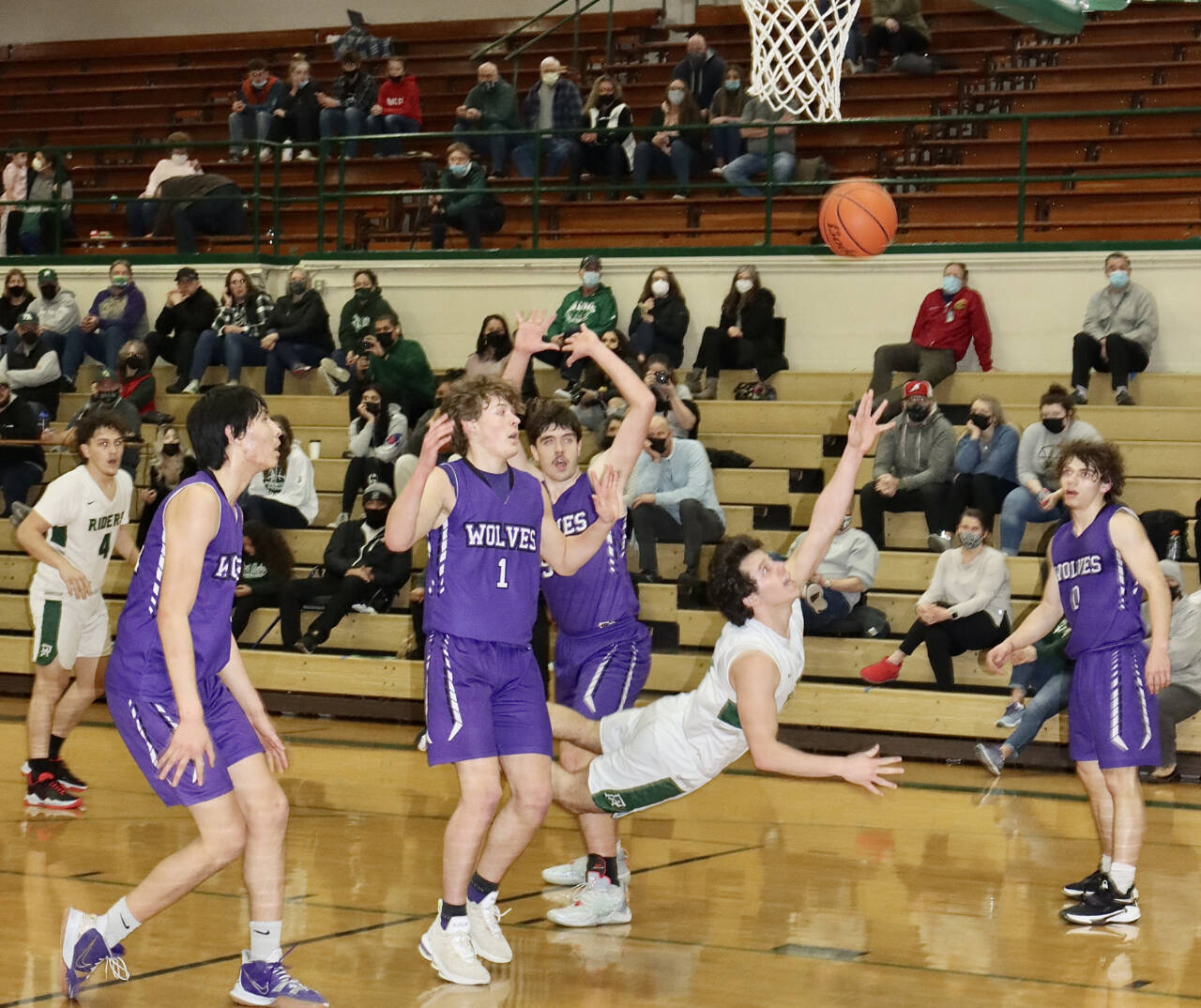 Port Angeles' Xander Maestas actually made this shot Saturday against Sequim and picked up a foul for a 3-point play. Also in on the play are, from left, Sequim's Isaiah Moore, Zach Thompson, Cole Smithson and Tyler Mooney. (Dave Logan/for Peninsula Daily News)