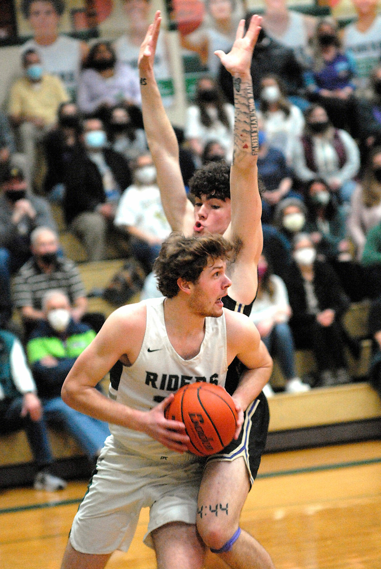 Keith Thorpe/Peninsula Daily News Port Angeles’ Wyatt Dunning, front, tries to evade the defense of North Kitsap’s Jonas La Tour during Thursday night’s game at Port Angeles High School.