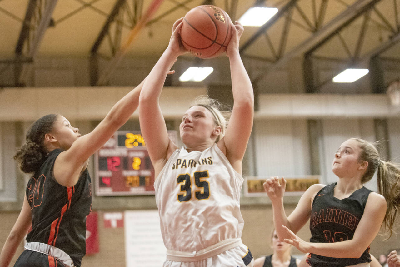 Forks junior Kyra Neel (35) hauls in a rebound in a 2B District IV playoff game against Rainier on Feb. 15 at Castle Rock High School. (Eric Trent/The Daily Chronicle)