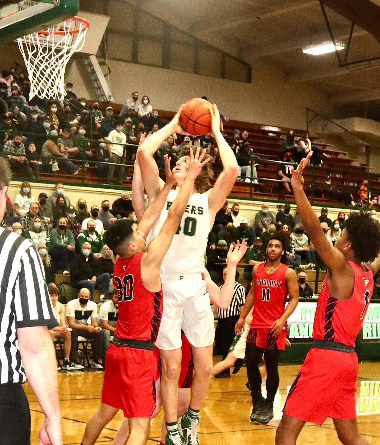 Port Angeles’ John Vaara soars over Franklin Pierce’s Brandon Herrera during the Roughriders’ 68-51 Class 2A District 2/3 tournament victory Wednesday. (Dave Logan/for Peninsula Daily News)