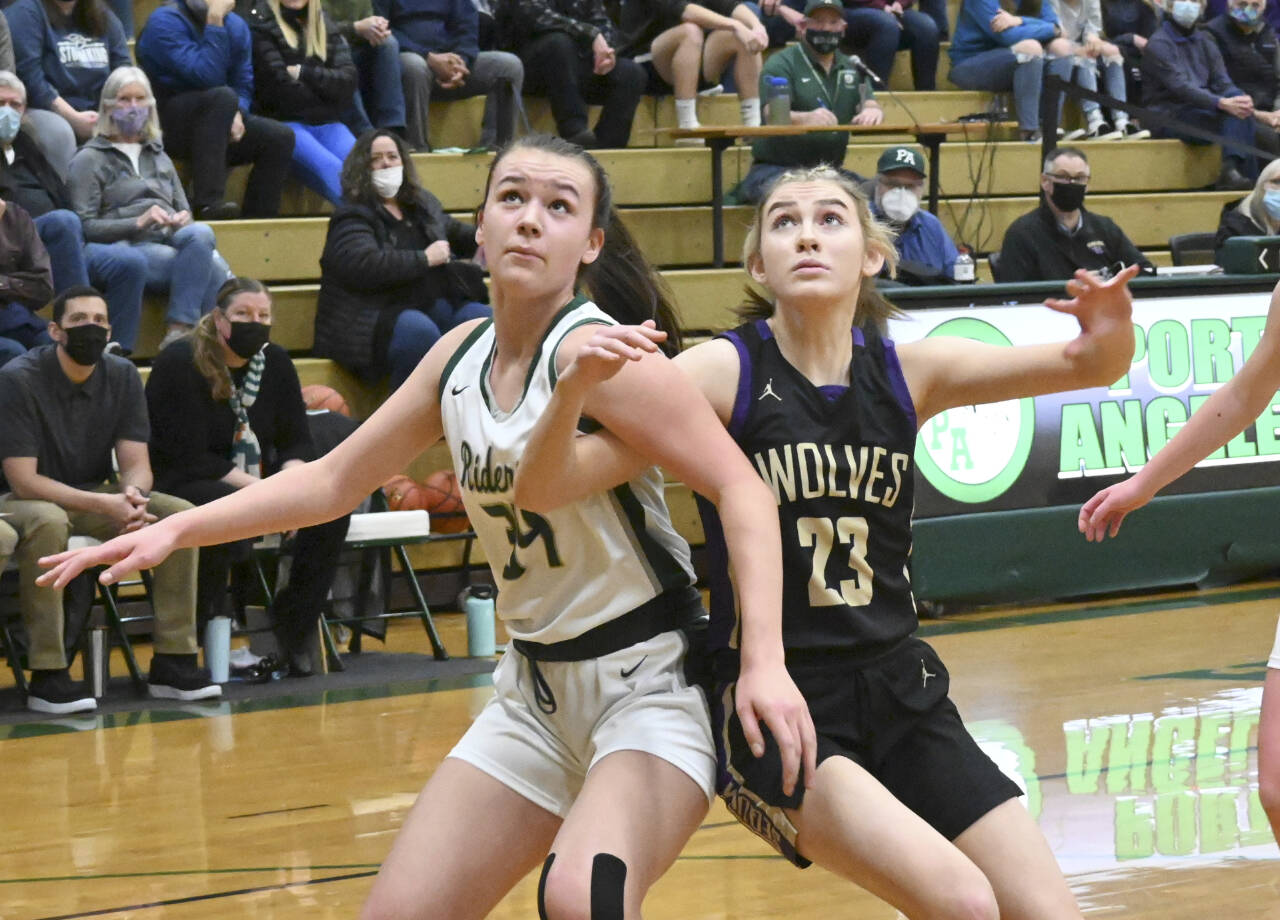 Port Angeles' Lexie Smith, left and Sequim's Lauryn Stephens battle for rebounding positions. (Michael Dashiell/Olympic Peninsula News Group)