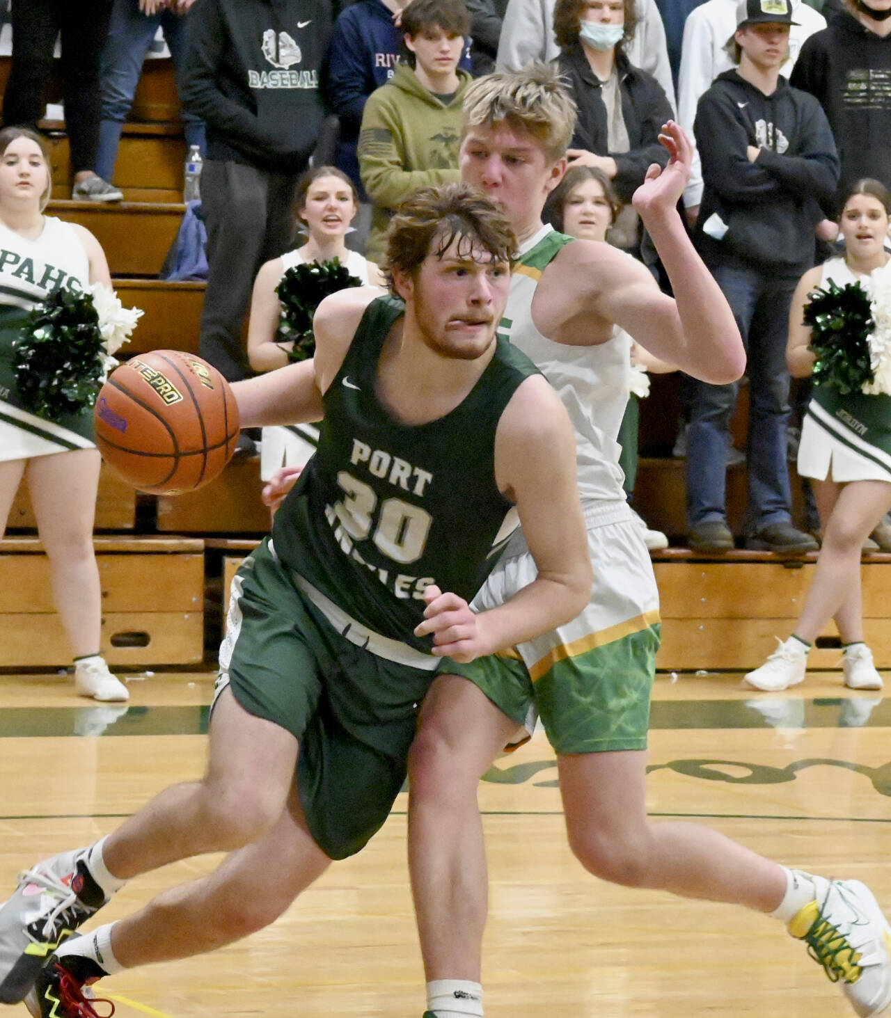 Port Angeles’ Wyatt Dunning drives around the defense of Lynden’s Kobe Bear in the 2A regionals held Friday night in Mount Vernon. (Michael Dashiell/Olympic Peninsula News Group)