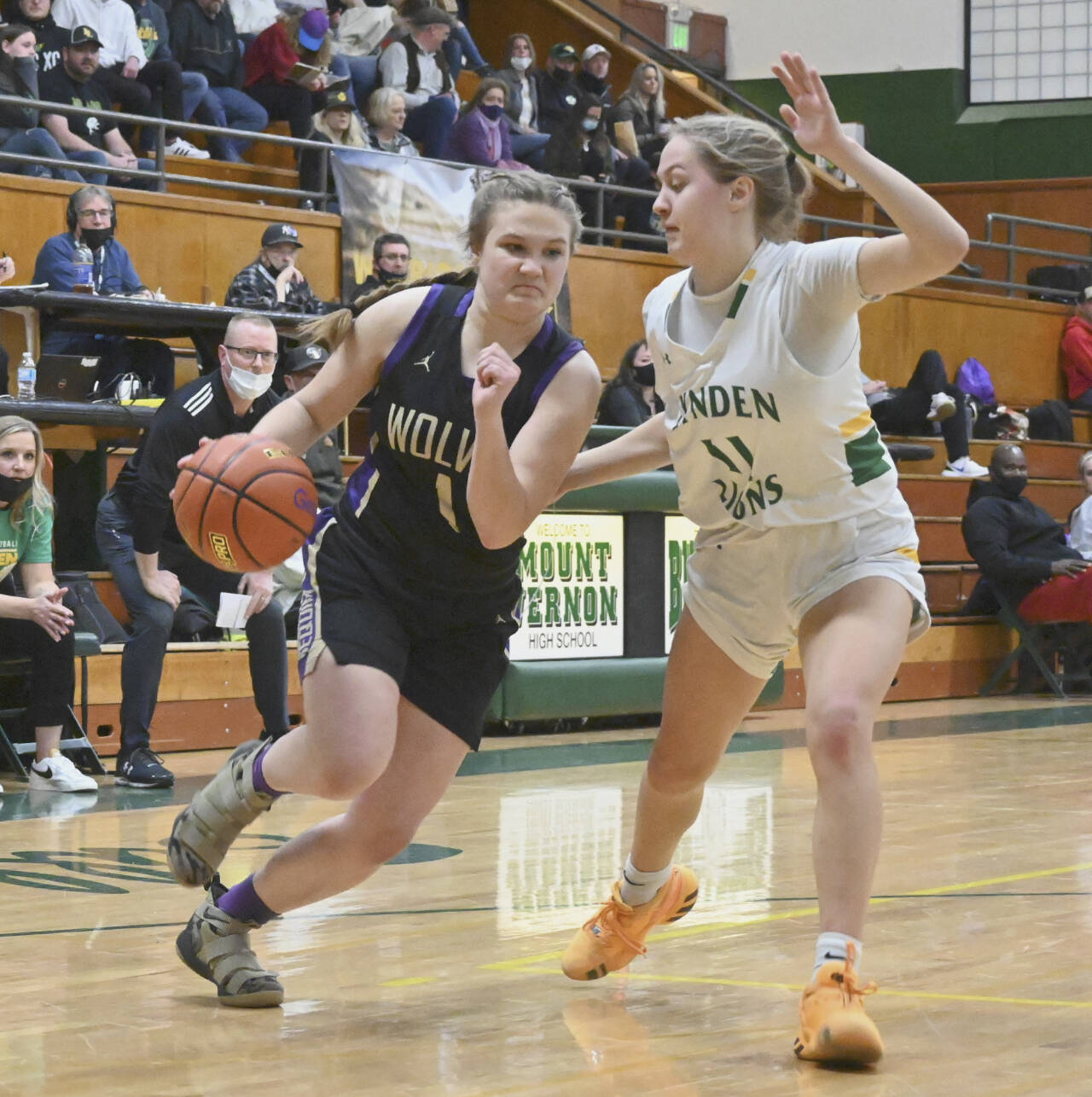 Sequim’s Addie Smith drives around Lynden’s Mallary Villars in the state 2A regional game held Friday night in Mount Vernon. (Michael Dashiell/Olympic Peninsula News Group)