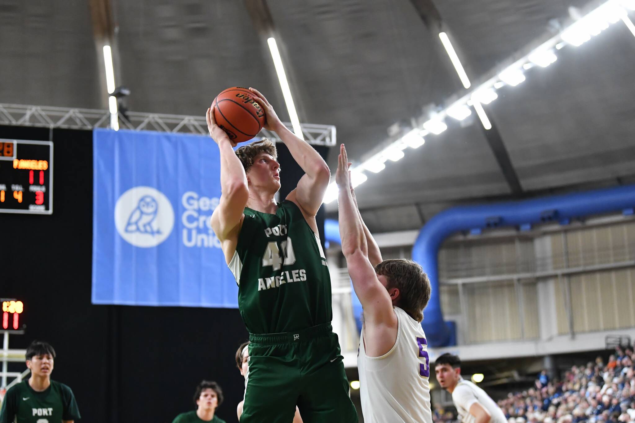 Jordan Nailon/The Daily News Port Angeles’ John Vaara puts up a shot over North Kitsap’s Colton Bower during the Roughriders’ 75-58 Class 2A state quarterfinal loss Thursday at the Yakima SunDome