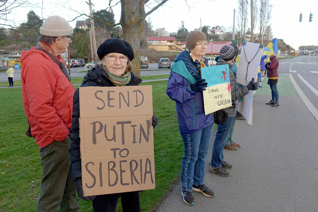 Marga Kapka of Port Townsend was among the 75 people who gathered at the corner of East Sims Way and Kearney Street in Port Townsend late Thursday to show solidarity with the people of Ukraine. Her Hungarian parents fled Budapest in July 1945 to escape the brutality of the Soviets who had liberated the city from the Nazis earlier that year, she said. Another rally is planned at 2 p.m. today at the intersection of Washington and Taylor Streets in Port Townsend. (Phil Lusk/for Peninsula Daily News)