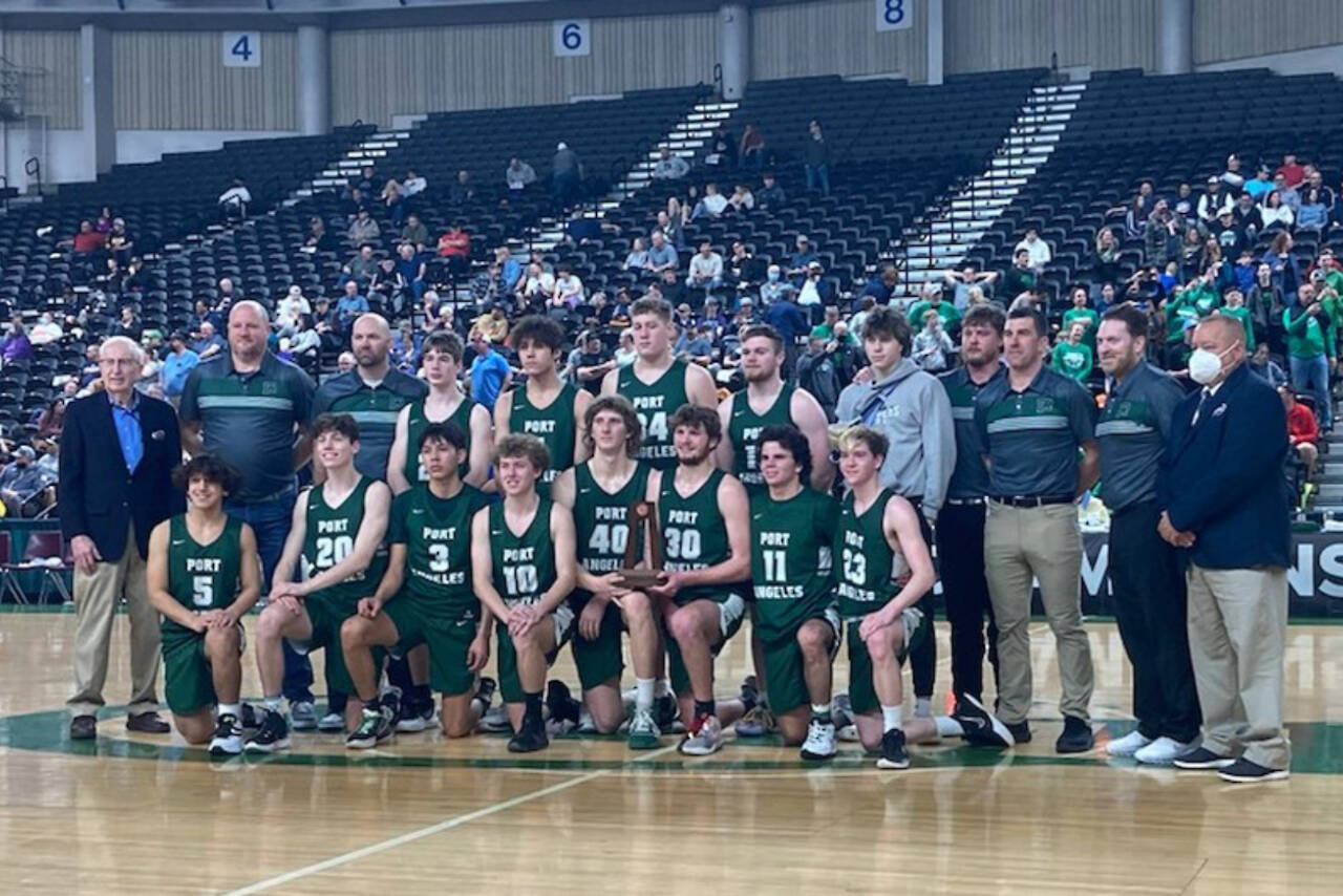 Port Angeles poses with the Class 2A Boys Basketball Tournament’s sixth-place trophy at the Yakima Valley SunDome on Saturday. The Roughriders finished 20-8 on the season, won a share of the Olympic League title and earned their first trophy at state since 1997.