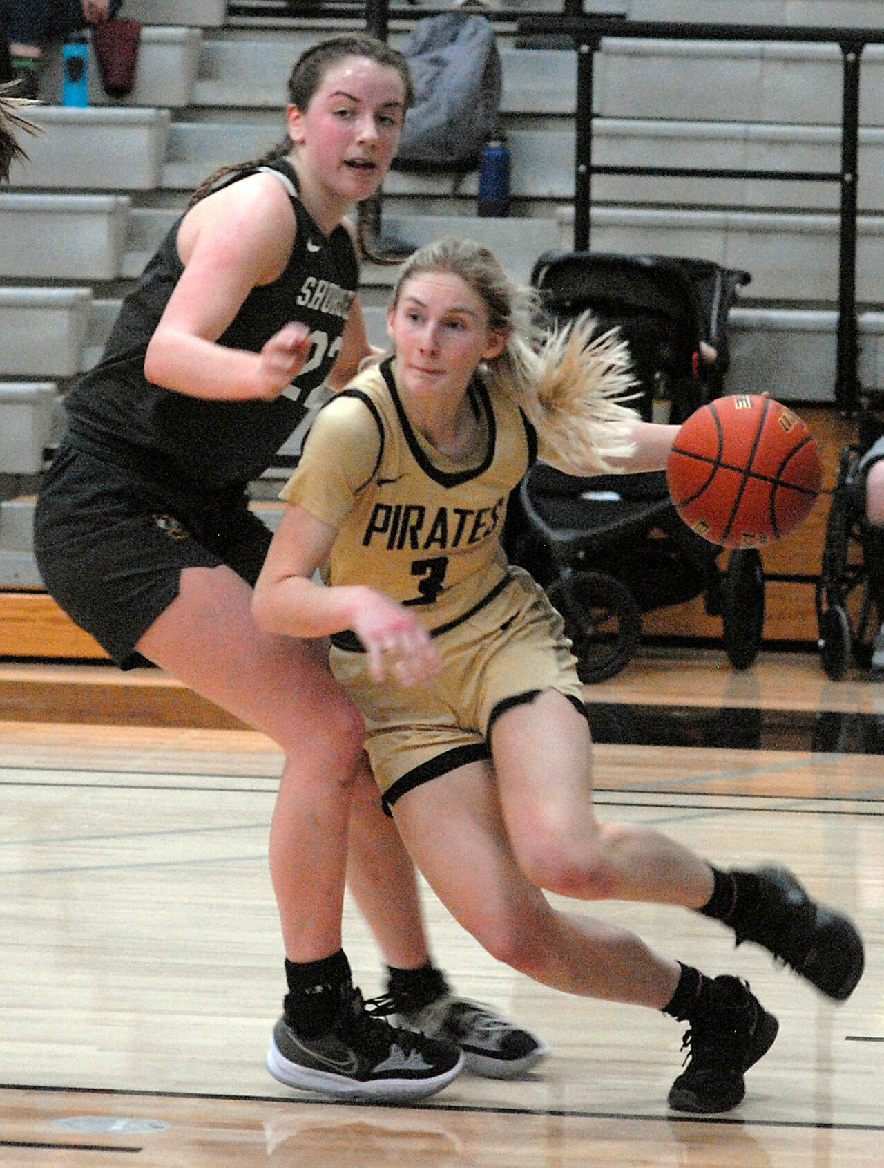 Peninsula’s Millie Long, right, drives past the defense of Shoreline’s Symone Pease during Wednesday’s season finale in Port Angeles. Long sprained her ankle in this game and the Pirates hope to have her back for the NWAC tournament that begins Saturday. (Keith Thorpe/Peninsula Daily News)