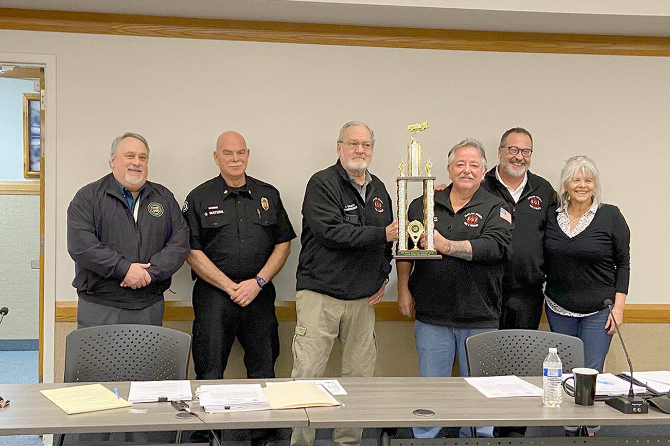 Pictured from left to right are Roger Ferris, executive director of the Washington State Fire Commissioners Association; Fire Chief Greg Waters; Commissioner Terry Barnett; Commissioner Ben Pacheco, commission chair; Commissioner Sam Nugent; and Commissioner Lynne Kastner.