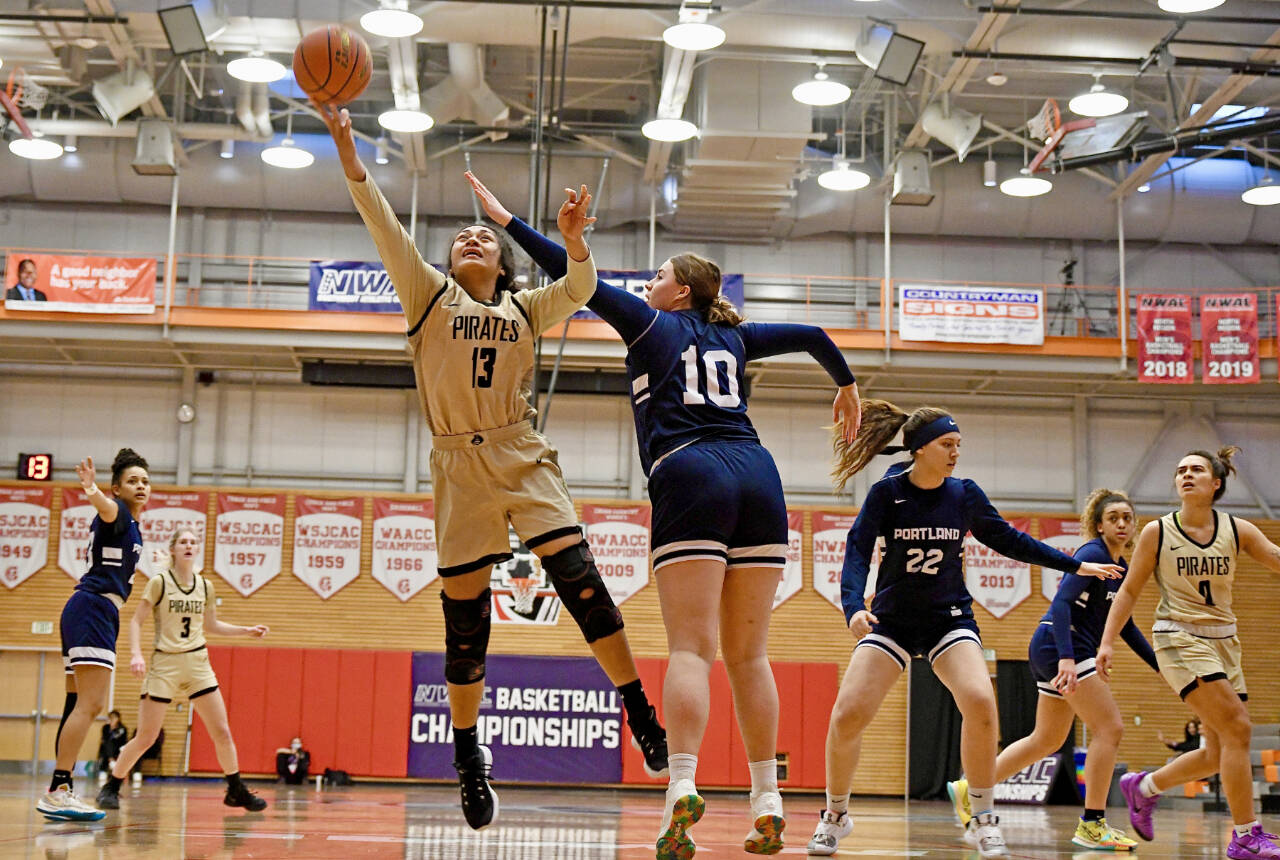 Peninsula Ituau Tuisaula (13) battles inside against Portland’s Iris Cubit (10) in the Pirates’ 64-59 win the NWAC Elite Eight on Sunday night. Also in on the play are Millie Long (3) and Keeli-Jade Smith (0). (Jay Cline/Peninsula College Athletics)