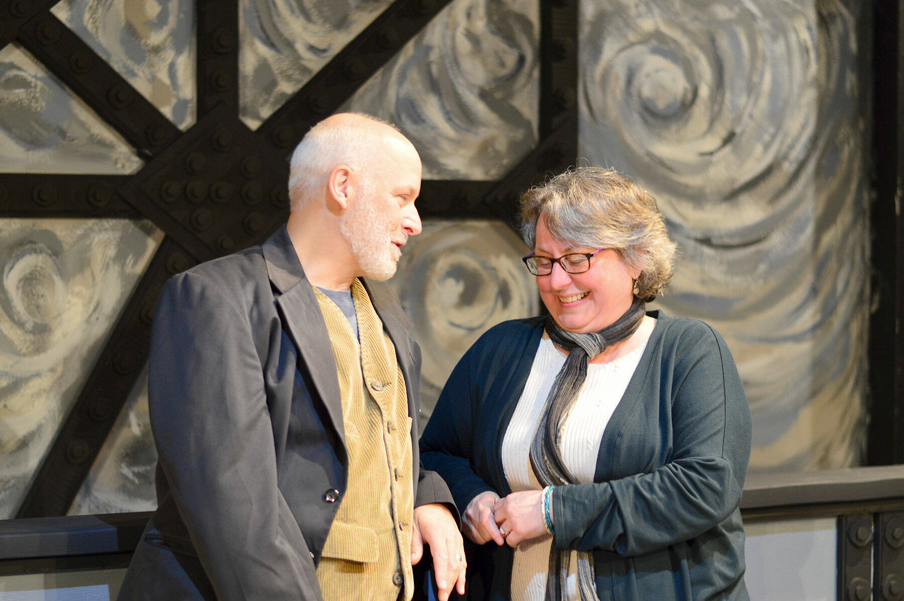 Inside the remodeled playhouse in Port Townsend, “Around the World in Less Than 80 Days” playwright and actor David Natale cracks up Denise Winter, the artistic director of Key City Public Theatre. The two, along with the cast and crew, have just opened ticket sales for the show’s world premiere. (Diane Urbani de la Paz/Peninsula Daily News)