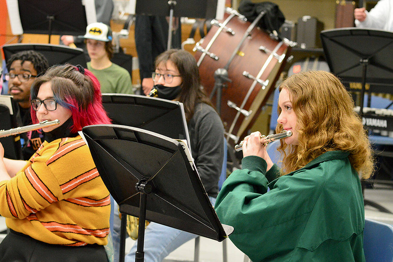 After many months of masking, flutists Gabby Mattern-Hall, left, and Sibyl Finman got to shed their face coverings for band practice earlier this month in George Rodes’ band room. (Diane Urbani de la Paz/Peninsula Daily News)