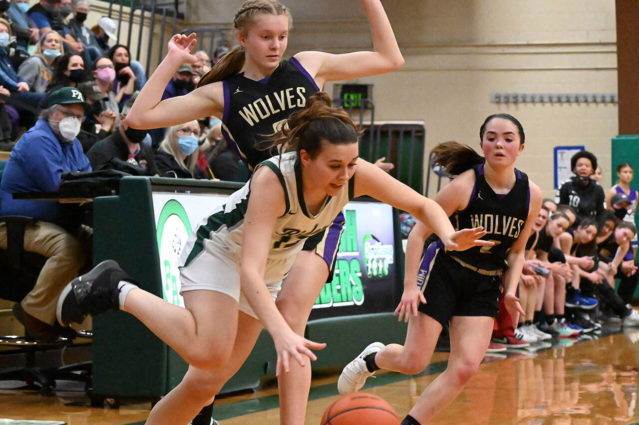 Sequim's Jolene Vaara, left, and Hannah Bates pressure Port Angeles' Bailee Larson in the first half of a West Central District playoff game in February in Port Angeles. All three players made the first all-Olympic girls basketball team. (Michael Dashiell/Olympic Peninsula News Group)