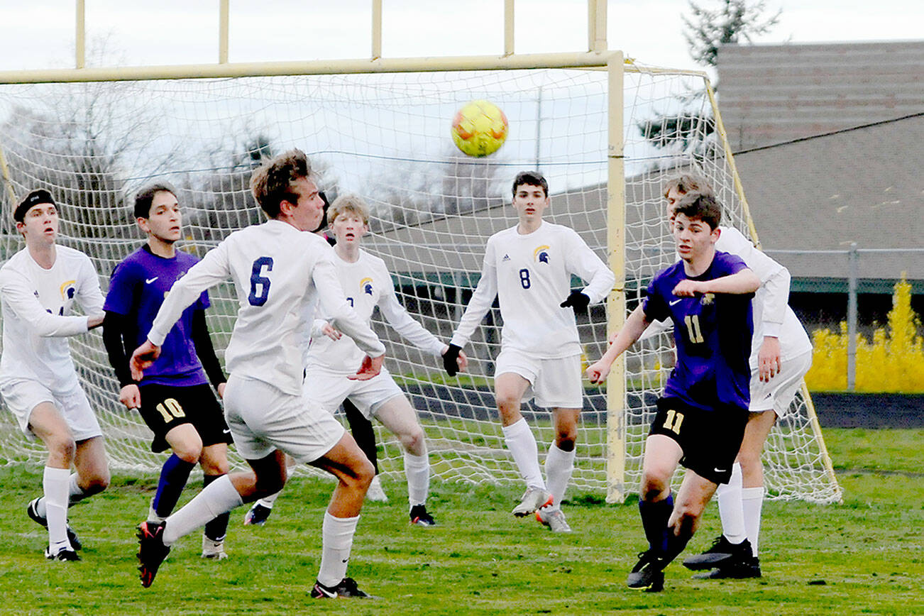 Michael Dashiell/Olympic Peninsula News Group
Sequim's Ethan Knight, right, is surrounded by Bainbridge defenders near the Spartans' goal box during the Wolves' 3-0 loss on Tuesday.