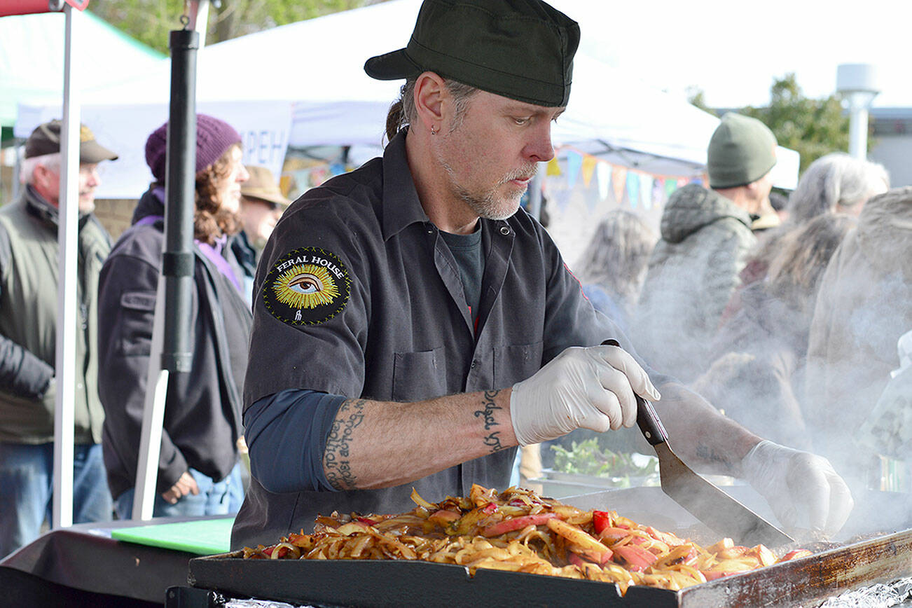 Barbarian Fine Cuisine’s Chris Kauffman was among the numerous cooks working opening day of the Port Townsend market on Saturday. (Diane Urbani de la Paz/Peninsula Daily News)