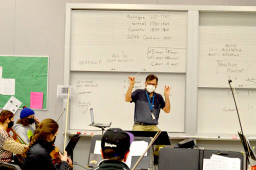 Orchestra teacher Daniel Ferland works with his students at Port Townsend High School. About 75 musicians recently traveled to the Central Washington University Orchestra Festival in Ellensburg. (Diane Urbani de la Paz/Peninsula Daily News)