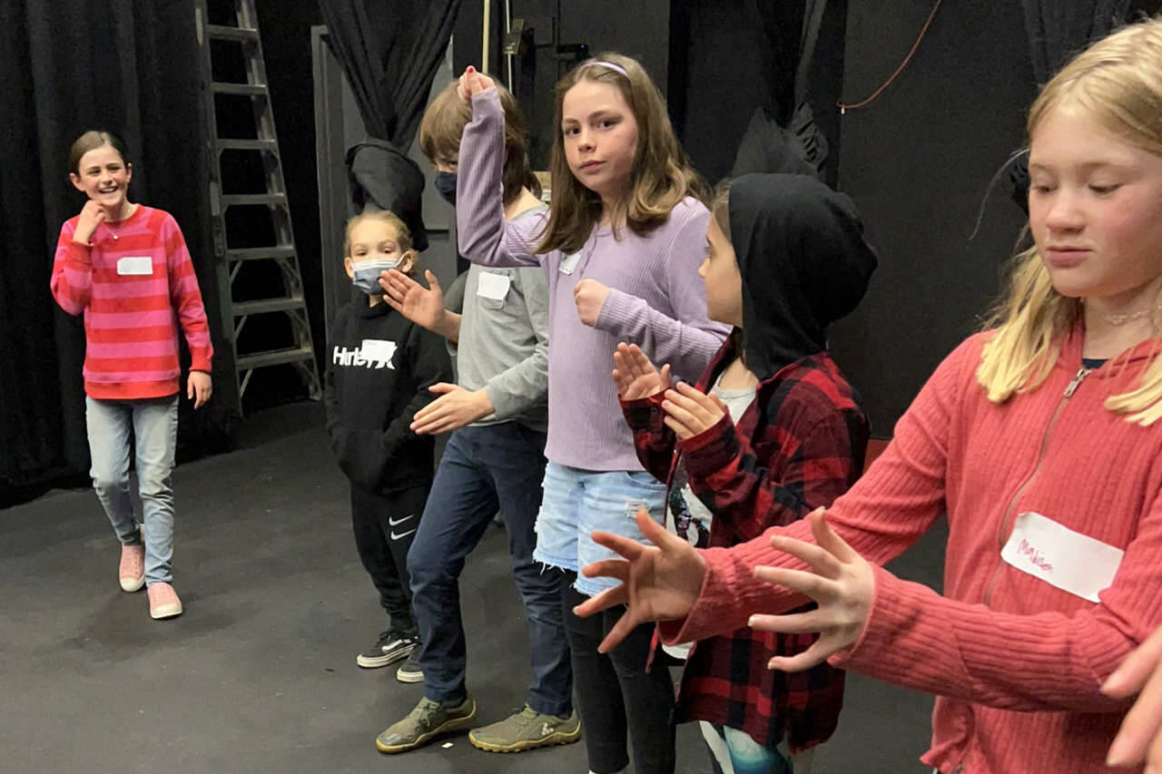 Young theater students read and direct each other in creating the factory machines that create candy, in preparing “Charlie and the Chocolate Factory” for April 9 performances. (Sarah Tucker and Marissa Meek)