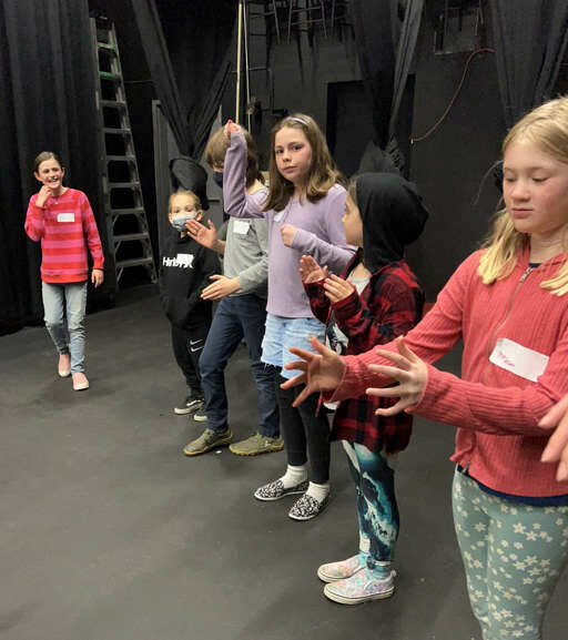 Young theater students read and direct each other in creating the factory machines that create candy, in preparing “Charlie and the Chocolate Factory” for April 9 performances. (Sarah Tucker and Marissa Meek)