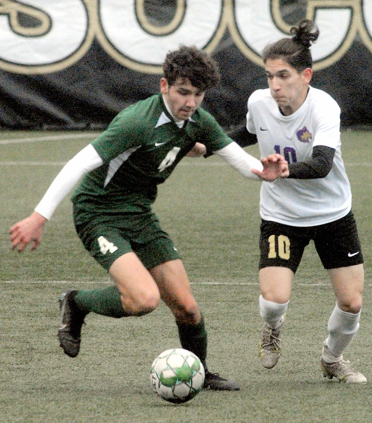 Port Angeles’ Keane McClain, left, and Sequim’s Rafael Flores battle for the ball on Tuesday evening at Peninsula College in Port Angeles. (Keith Thorpe/Peninsula Daily News)