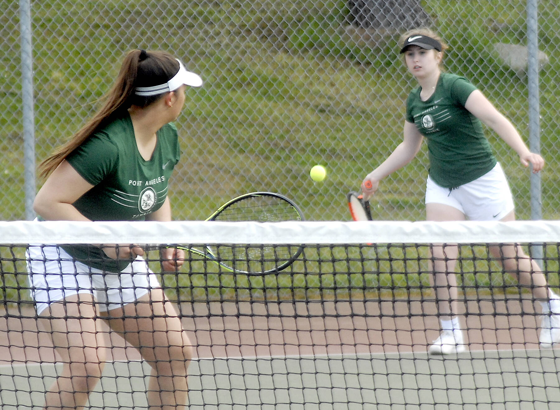 Keith Thorpe/Peninsula Daily News
Port Angeles double team members Angelina Sprague, left, and Kinnley Brady compete against the Bainbridge Island team of Emily Knighton and Kristina Walker on Friday at Port Angeles High School.