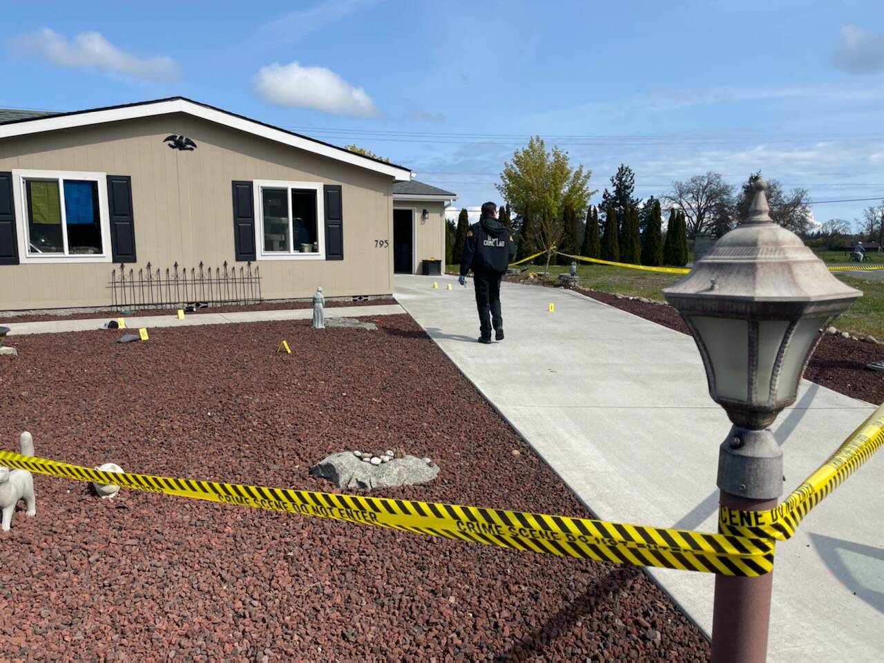 State Patrol’s Crime Scene Response Team members survey a scene near West Hendrickson Road on Thursday where a Sequim man allegedly tried to shoot his neighbor the evening prior. (Matthew Nash/Olympic Peninsula News Group)