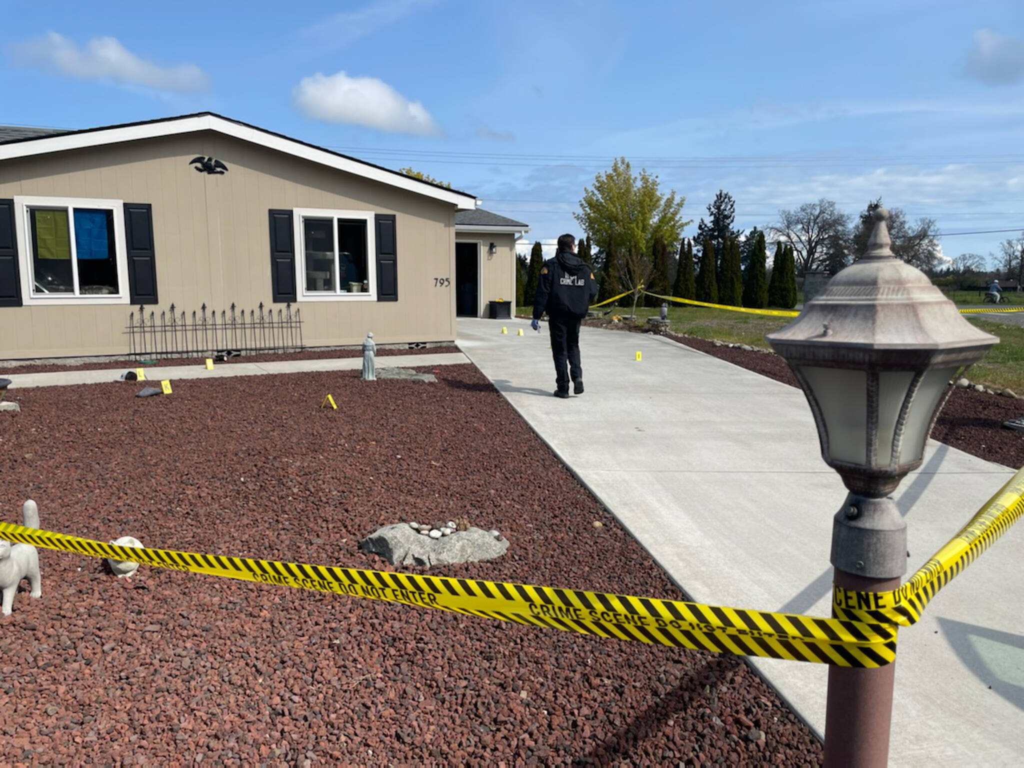 State Patrol’s Crime Scene Response Team members survey a scene near West Hendrickson Road on Thursday where a Sequim man allegedly tried to shoot his neighbor the evening prior. (Matthew Nash/Olympic Peninsula News Group)