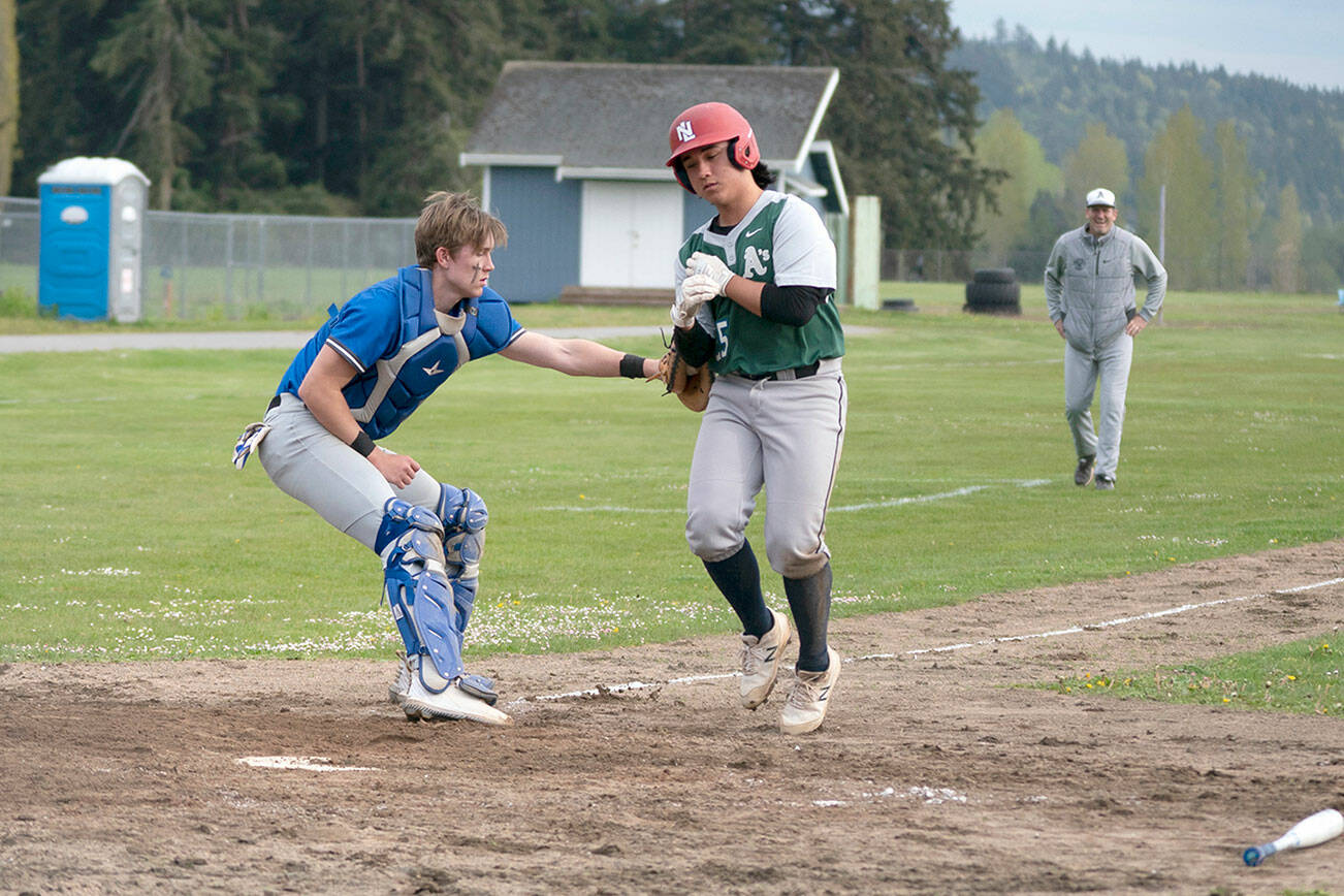 Rival catcher Cash Holmes tags out Charles Wright’s Nico Rose as he was trying to score a run in the 2nd game of a Wednesday double-header played in Chimacum.