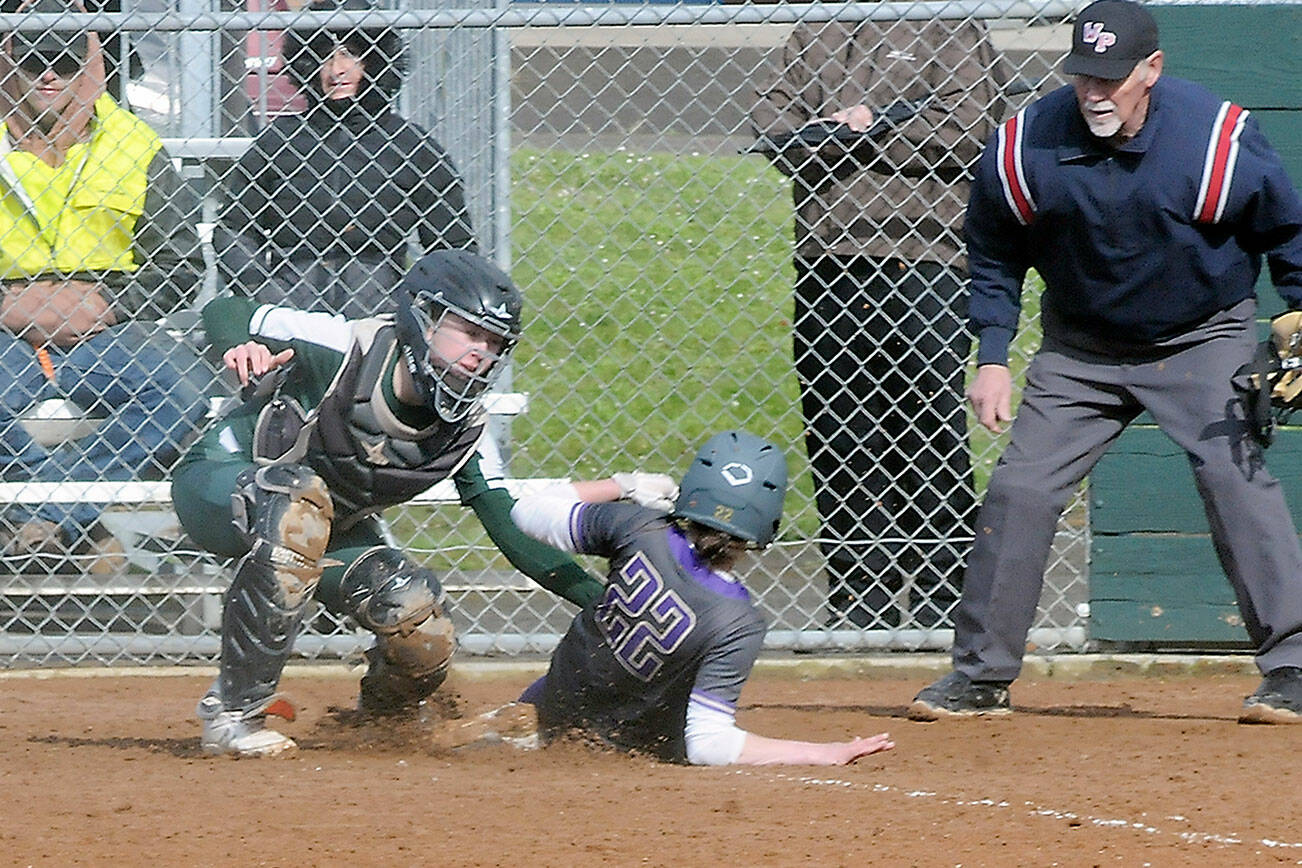 Keith Thorpe/Peninsula Daily News
Port Angeles catcher Zoe Smithson, left, tags out North Kitsap's Alison Dovorak at home plate on Thursday in Port Angeles.