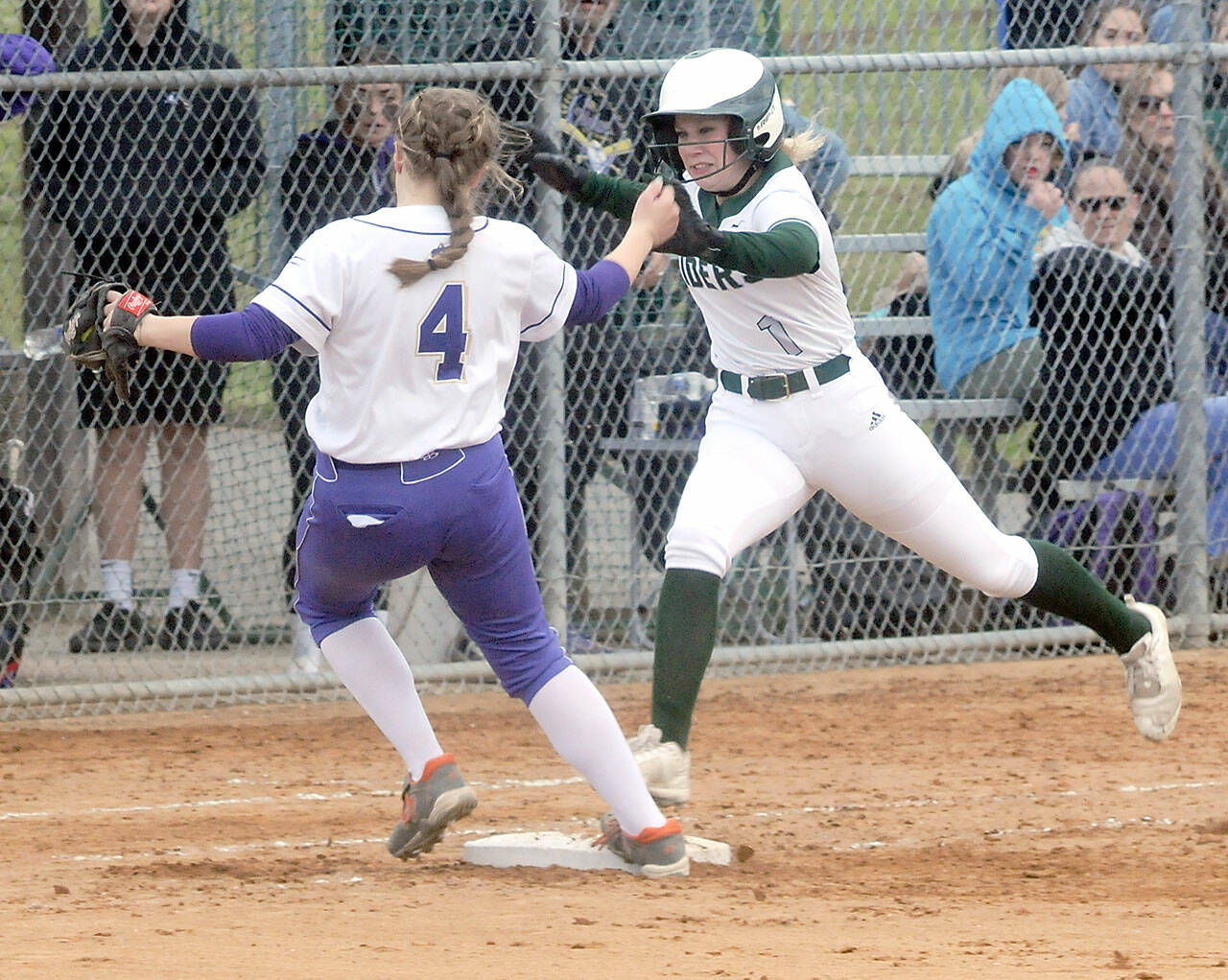 Sequim second baseman Addie Smith just avoids a collision with Port Angeles baserunner Heidi Leitz at first base during Friday’s game at Dry Creek in Port Angeles. (Keith Thorpe/Peninsula Daily News)