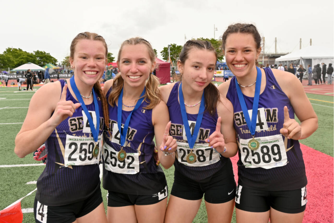 From left, Riley Pyeatt, Hi’ilei Robinson, Kaitlyn Bloomenrader, Eve Mavy, members of the Sequim girls 4x400 relay team, celebrate their state championship at the 2A meet at Mount Tahoma Stadium on Saturday. (Michael Dashiell/Olympic Peninsula News Group)