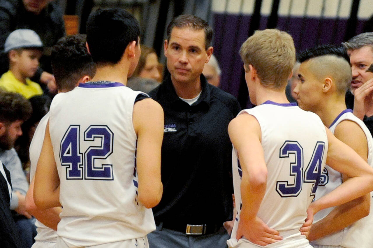 Sequim High head coach Greg Glasser, center, talks to Isaiah Moore, left, and Erik Christiansen during a timeout in the Wolves’ 51-46 win over North Mason in January 2020. (Olympic Peninsula News Group file photo)