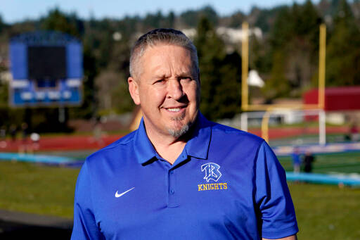 Joe Kennedy, a former assistant football coach at Bremerton High School, poses for a photo March 9, 2022, at the school’s football field. The Supreme Court has sided with a football coach who sought to kneel and pray on the field after games. The court ruled 6-3 along ideological lines, saying the coach’s prayer was protected by the First Amendment. (Ted S. Warren/The Associated Press)