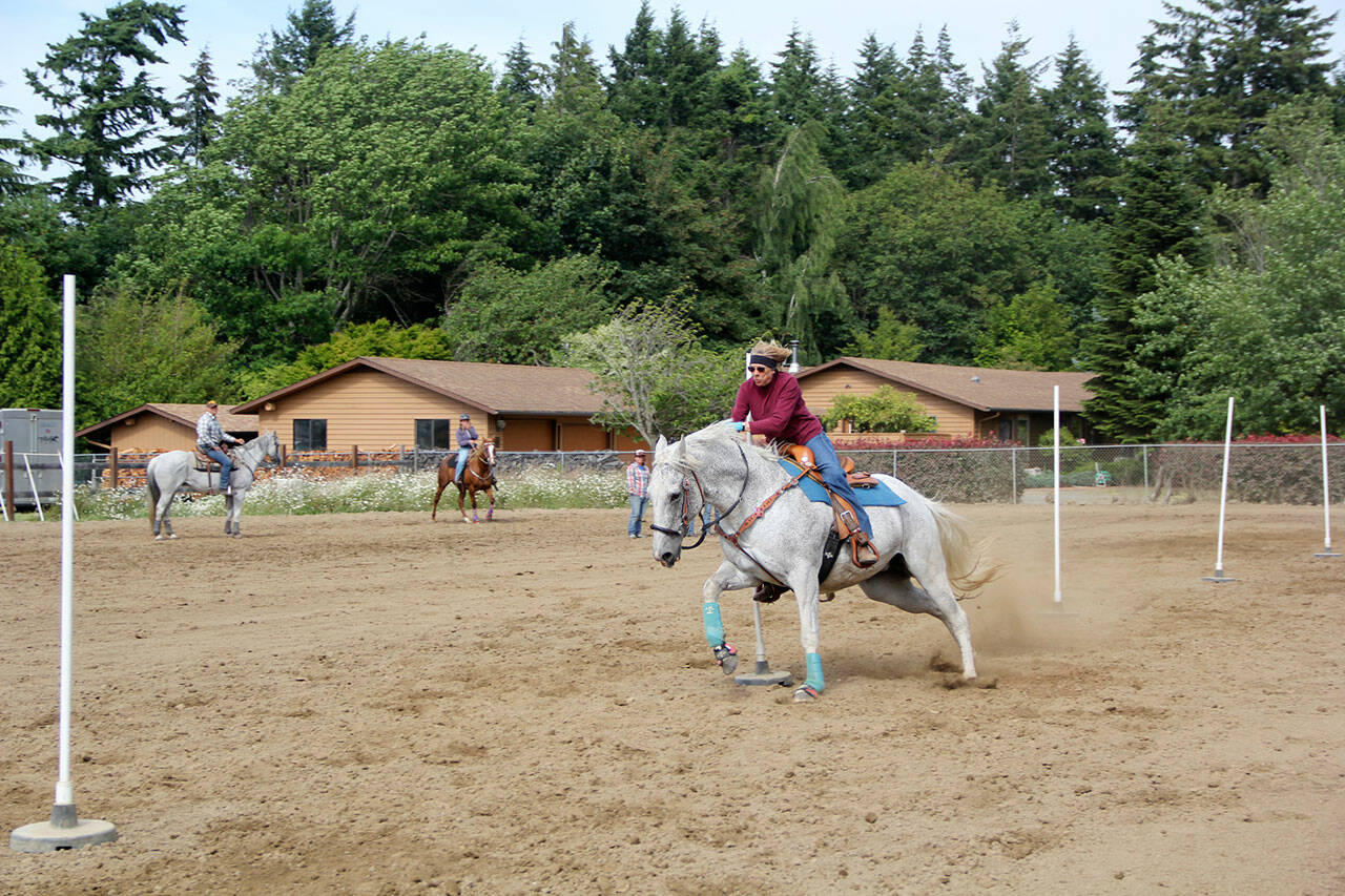 Patterned Speed Horse Association member and highpoint winner Waynora Martin, riding Belle, powers through the pole bending competition at the Crosby Arena in Agnew. (Karen Griffiths / for Peninsula Daily News)