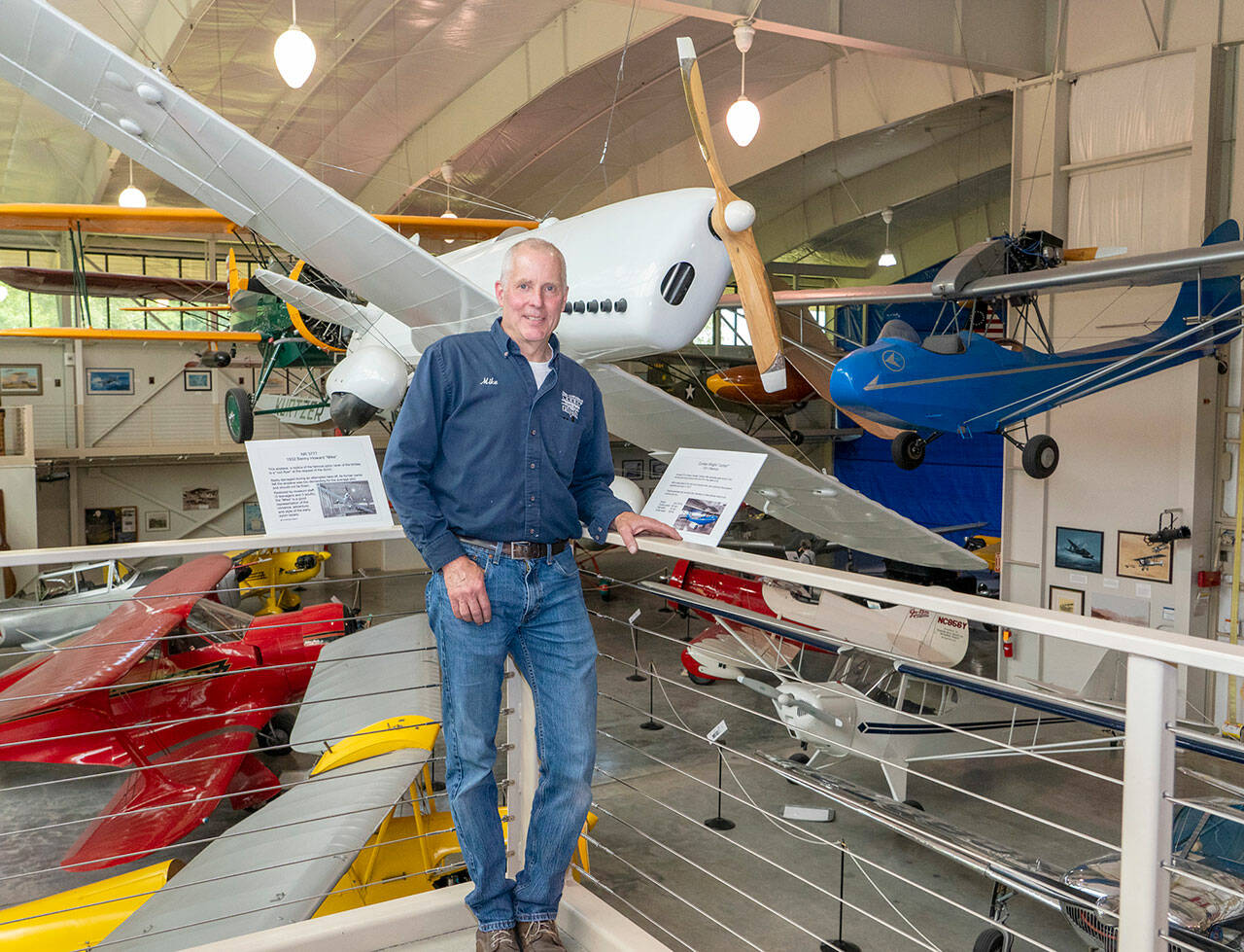 Michael Payne, Executive Director of the Port Townsend Aero Museum, shows off some of the antique and historic air planes on display at the museum located at the Jefferson County International Airport in Port Townsend. The museum is expanding, in the area behind the blue tarp in the background, to increase the museum’s display area by about a third. (Steve Mullensky/for Peninsula Daily News)