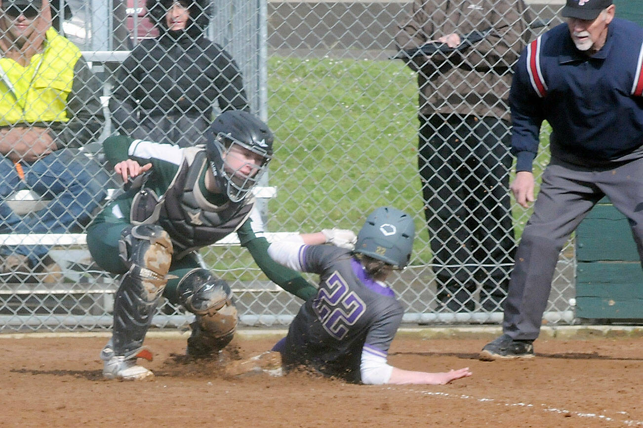 Keith Thorpe/Peninsula Daily News
Port Angeles catcher Zoe Smithson, left, tags out North Kitsap's Alison Dovorak at home plate on Thursday in Port Angeles.