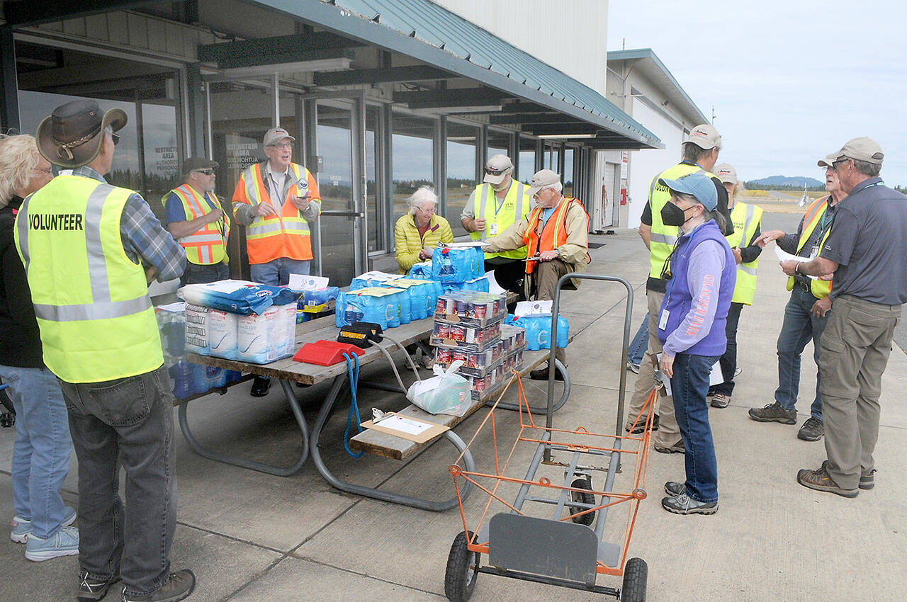 Clallam County Disaster Airlift Response Team members assemble food and water for a training session on Saturday at William R. Fairchild International Airport in Port Angeles that sent food supplies to five smaller airports across the county. (Keith Thorpe/Peninsula Daily News)