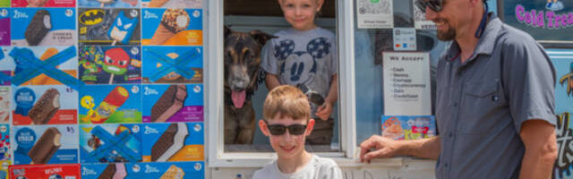 From left to right, Mr. Orange and Justin, Charlie and Joe Parker pause inside and outside their ice cream truck in Sequim. Northwest Treats has no fixed route, but travels all over Sequim and Port Angeles and in between and as far as Lake Sutherland and the lower Elwha. Joe Parker says that “people message us to come by,” using text, instagram and Facebook.  Emily Matthiessen/Olympic Peninsula News Group