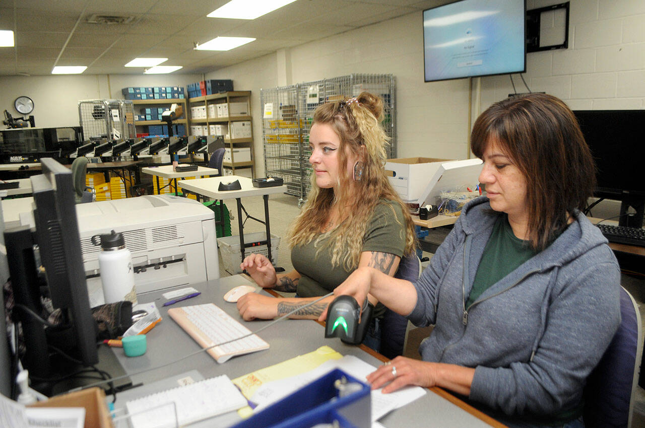 Clallam County Elections Assistant Aspen Smith, left, and Elections Manager Susan Johnson examine contested ballots on Tuesday at the Clallam County Courthouse. (Keith Thorpe/Peninsula Daily News)