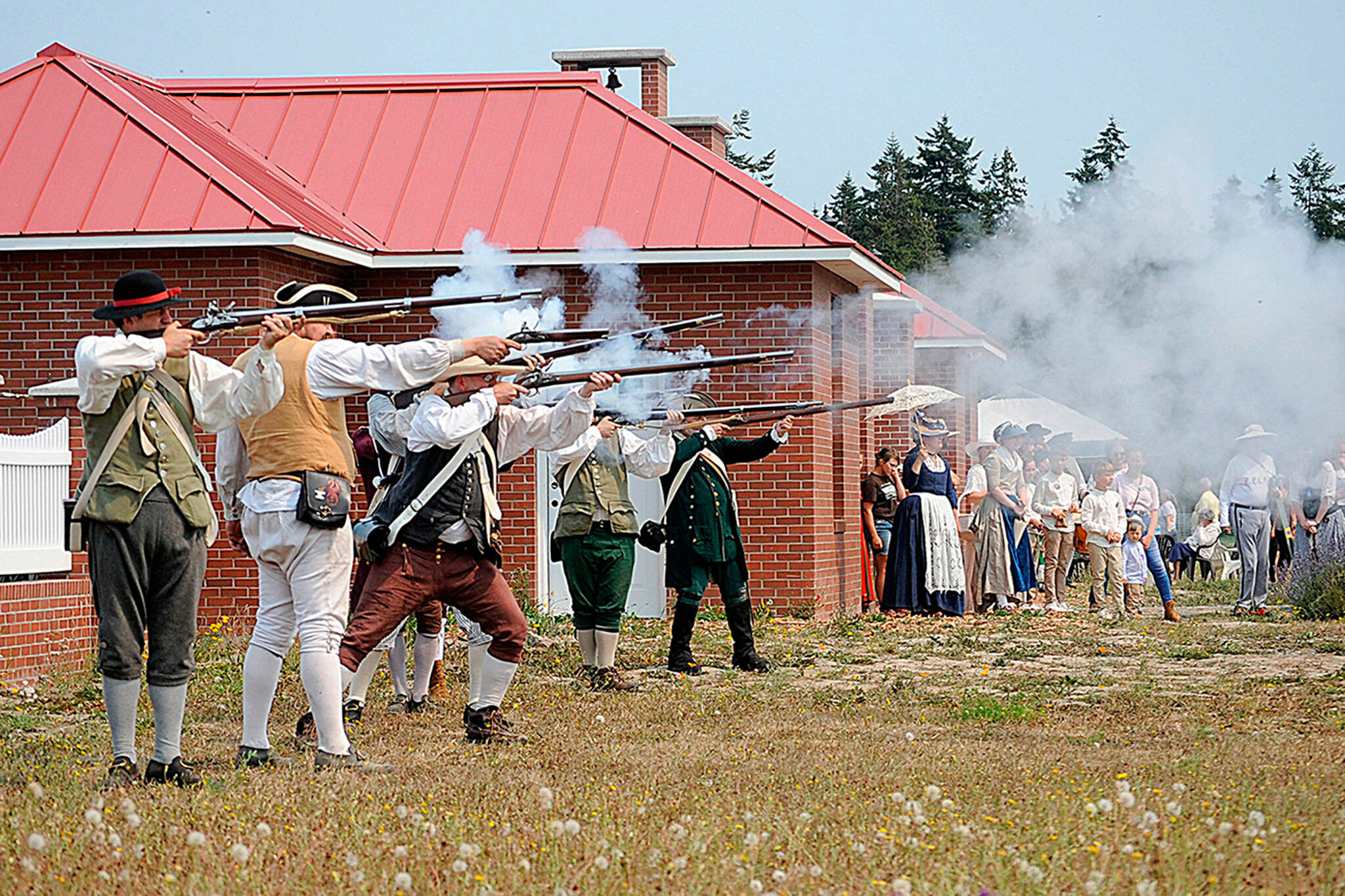 Matthew Nash / Olympic Peninsula News Group
Colonial soldiers shoot at the British in a skirmish reenactment during the Northwest Colonial Festival in 2021. It returns for four days today through Sunday with skirmishes and demonstrations at the George Washington Inn.