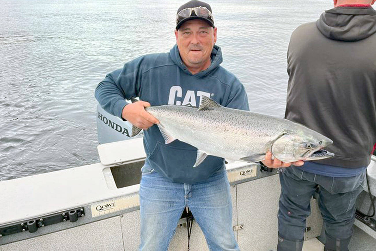 Port Angeles angler Justin Peterson landed this good-sized hatchery chinook while fishing just off shore at the Caves near Sekiu.