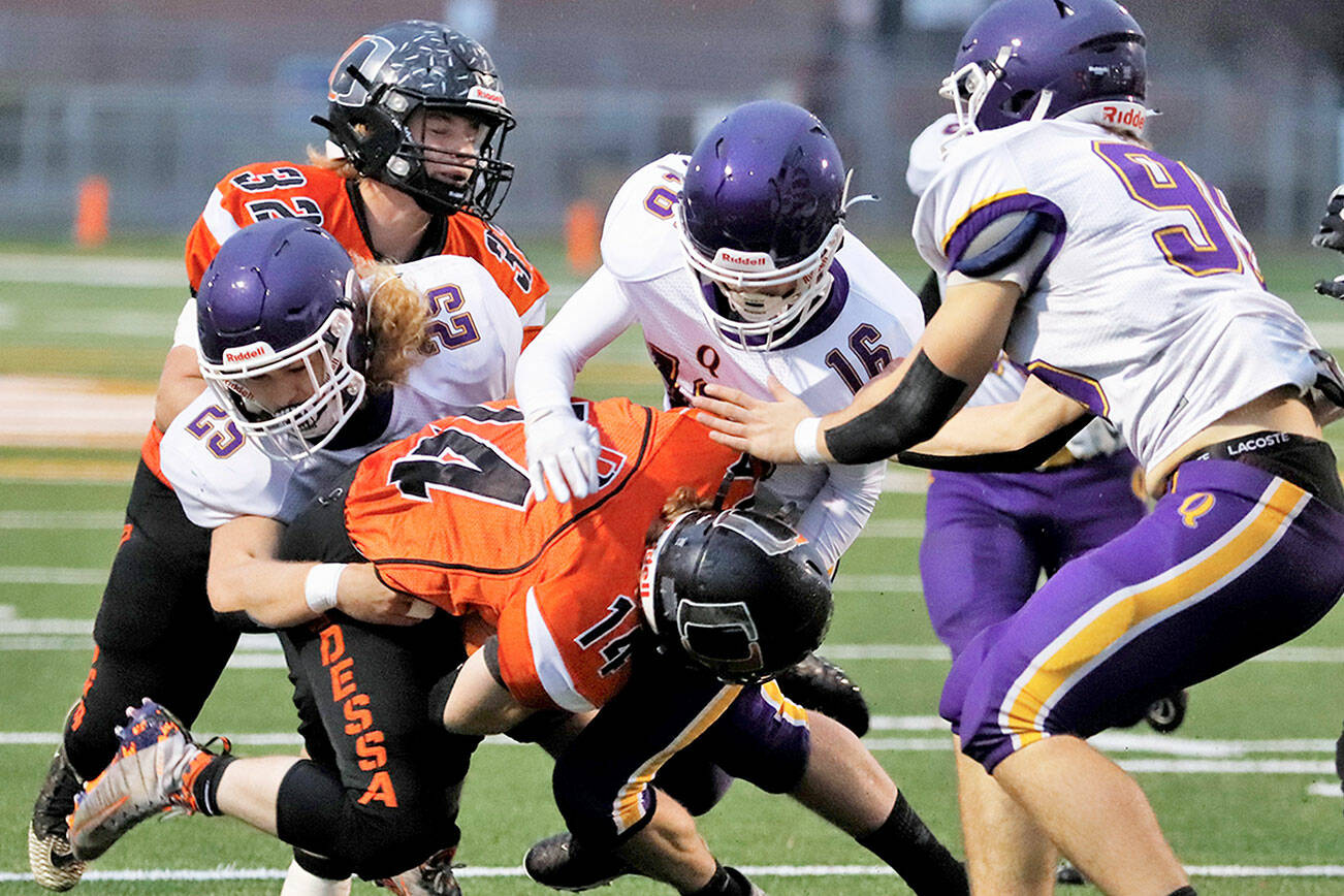 Roger Harnack/Cheney Free Press
Quilcene's, from left, Ashton Johnston, Isaiah Reimann and Deakon Budnek corral an Odessa runner during the Rangers' state semifinal win in 2021.