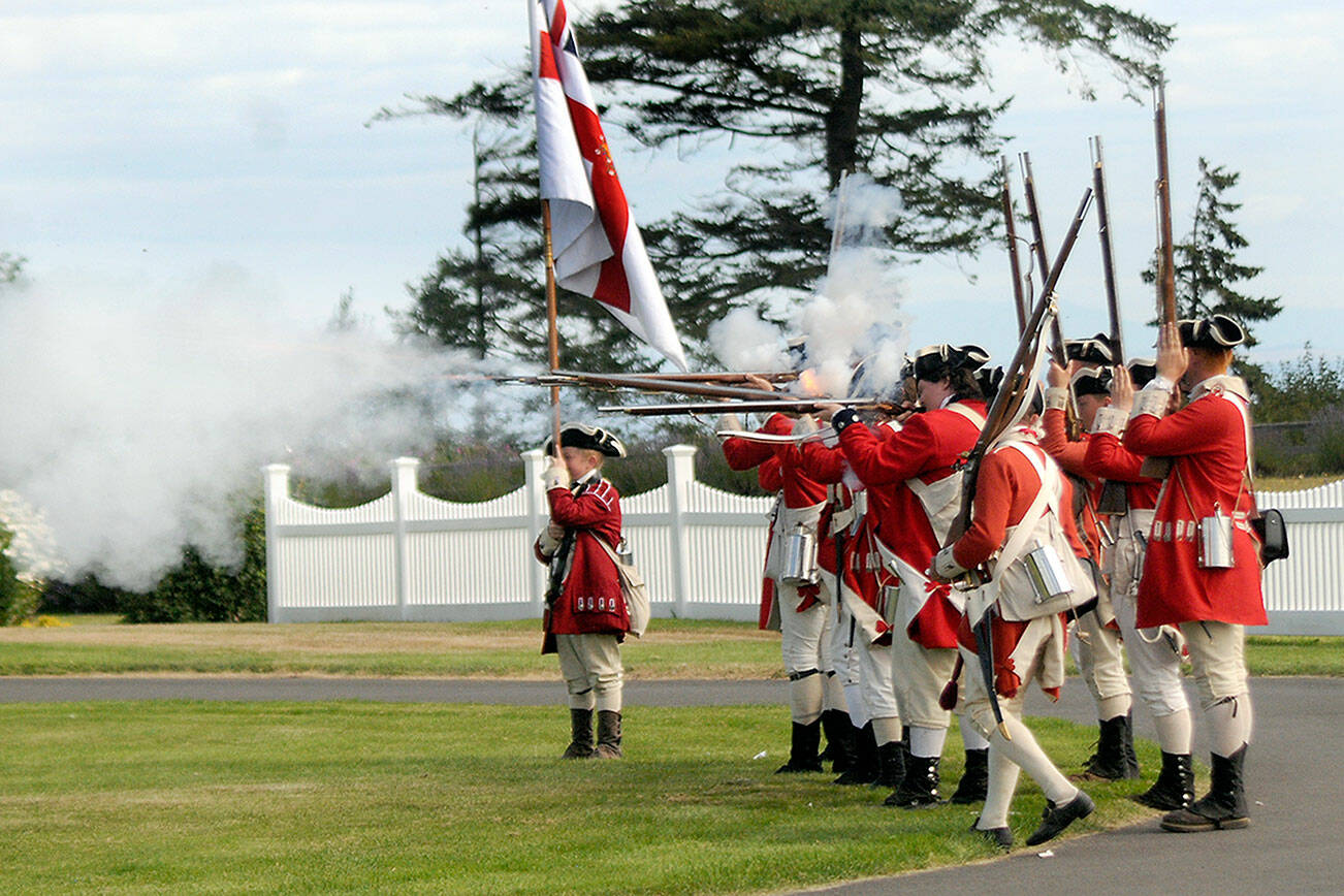 Keith Thorpe/Peninsula Daily News
A group of Revolutionary War re-enactors, playing part of British soldiers, fire their guns during a mock battle during the 2022 NW Colonial Festival at the George Washington Inn and Estate near Agnew. The eighth-annual event featured historical demonstrations, childrens activities, educational discussions about life in the 1700s and skirmishes between British Regulars and a colonial militia.