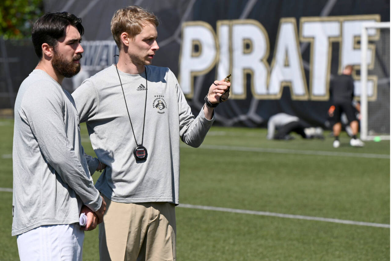 Photo courtesy of Peninsula College 
Peninsula College men's soccer coach Jake Hughes, right, talks with assistant Jesse Salgado during practice earlier this month at Wally Sigmar Field. The Pirates begin their season Thursday at home with a game against Wenatchee CC.