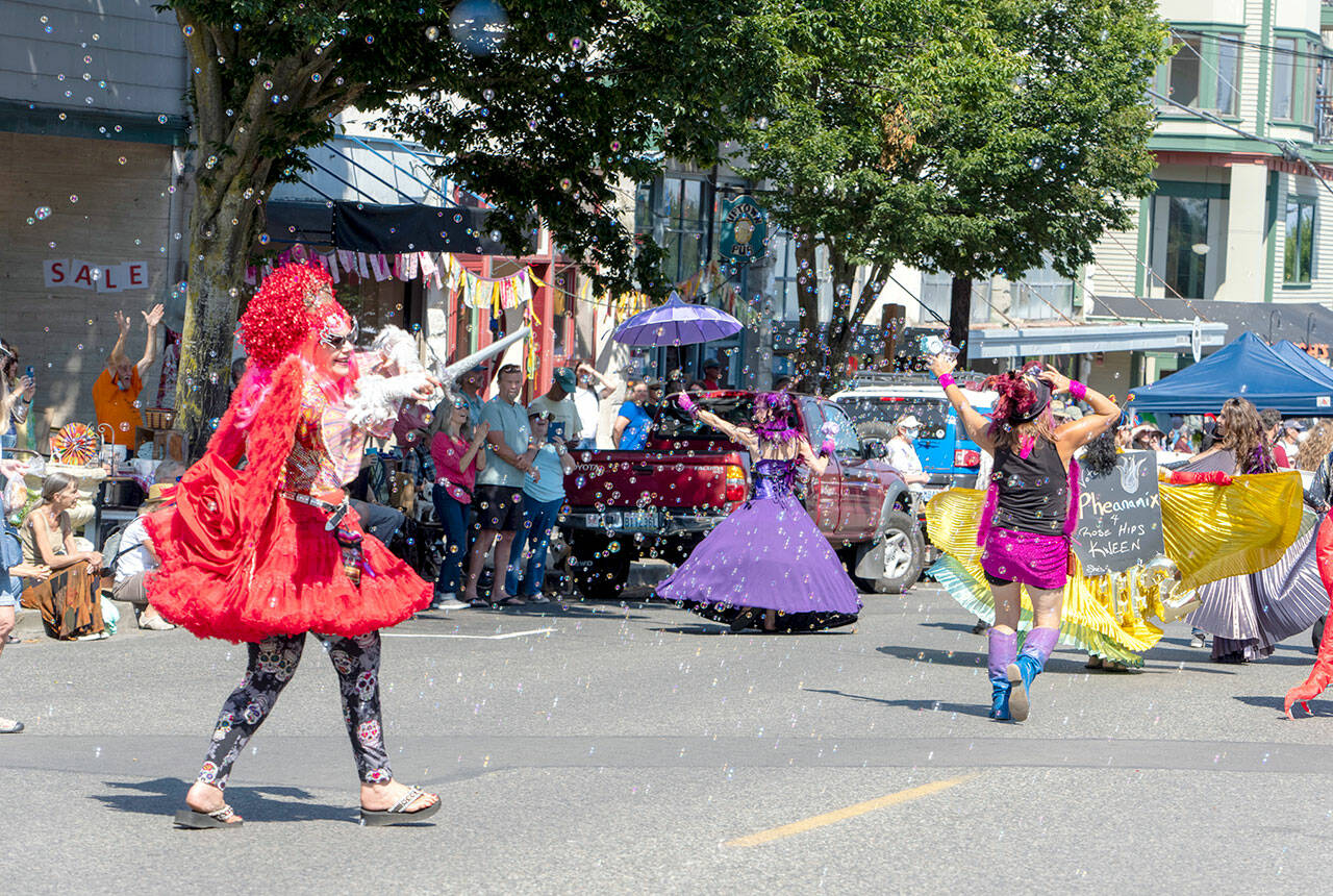 Uptown Fair parade marchers prance through the glitter of tiny bubbles during the fair on Saturday. (Steve Mullensky/for Peninsula Daily News)