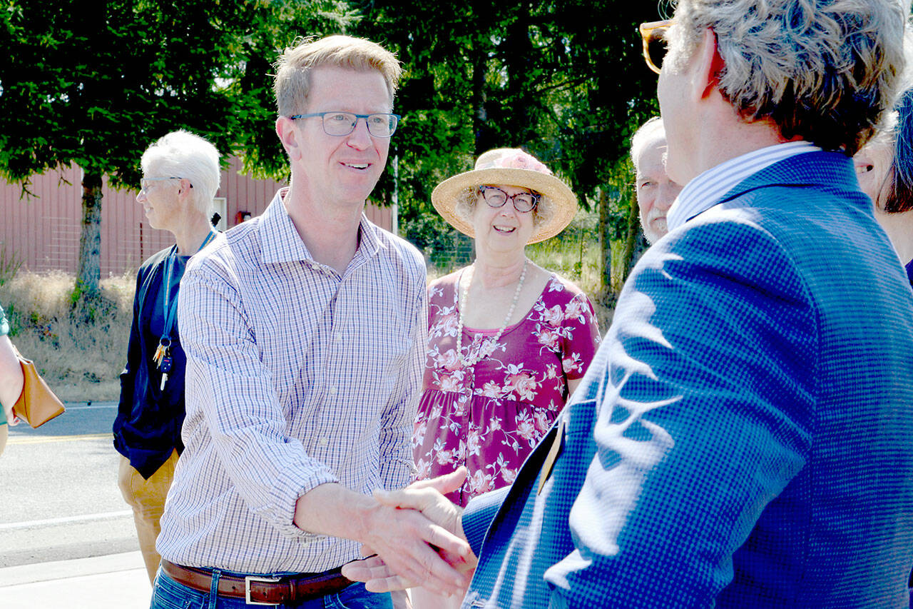 U.S. Rep. Derek Kilmer, a Democrat representing Washington’s 6th Congressional District, shakes hands with Chimacum School District Superintendent Scott Mauk in Port Hadlock on Wednesday. Kilmer visited the sites of two sewer projects his office is working on securing federal funding for. (Peter Segall / Peninsula Daily News)