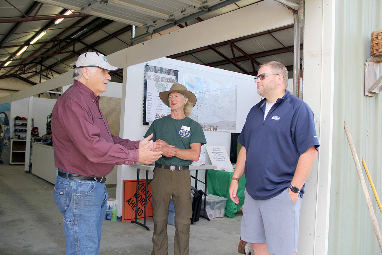 BCH Buckhorn Range member, and Jefferson County Assessor Jeff Chapman, left, with fellow member Bob Hoyle and State Representative Mike Chapman discuss some of the problems and possible solutions to keeping dedicated multi-use trails open to horses, along with preserving the ruralness of Miller Peninsula State Park for “our kids and future generations,” emphasized Mike Chapman. (Karen Griffiths/For Peninsula Daily News)